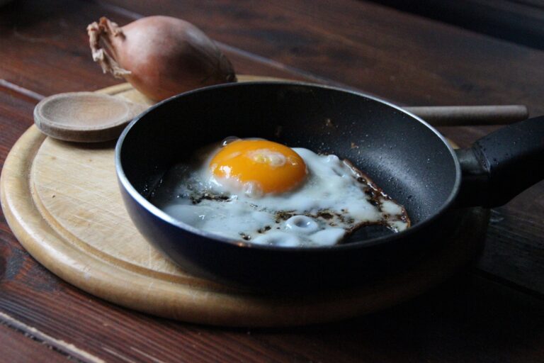 An egg is frying in a skillet. As a blind man, Cameron using the sound to determine when it's done. 