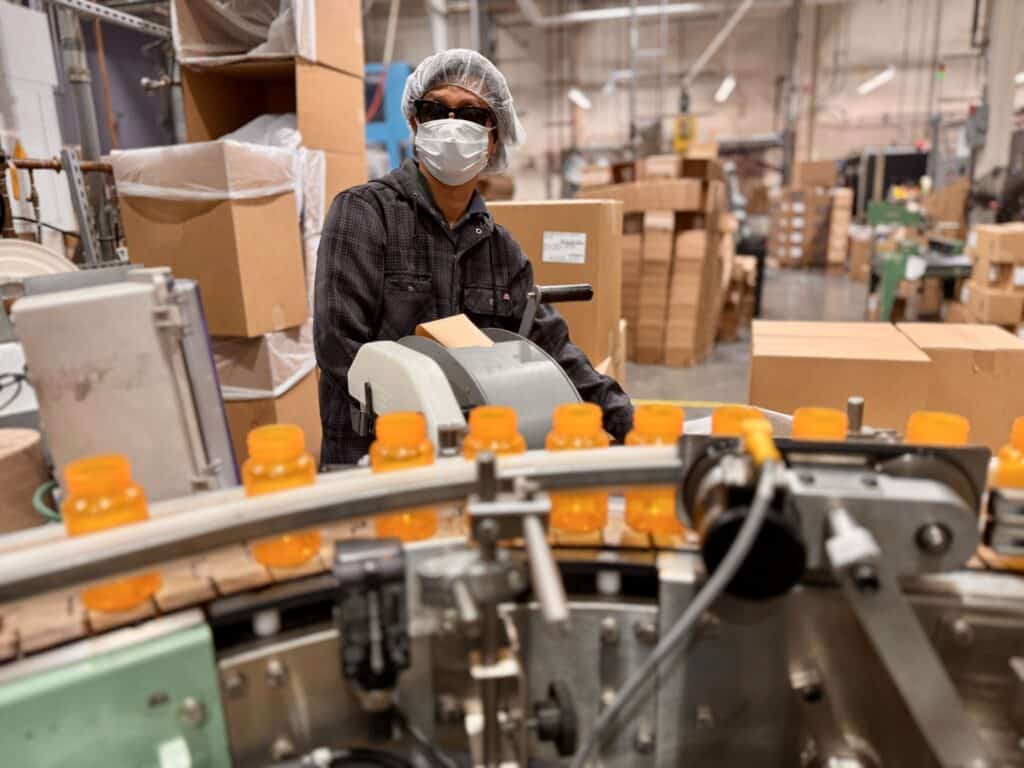 Thomas is preparing boxes from the prescription bottles that are manufactured in the Alphapointe Plastics Department. 