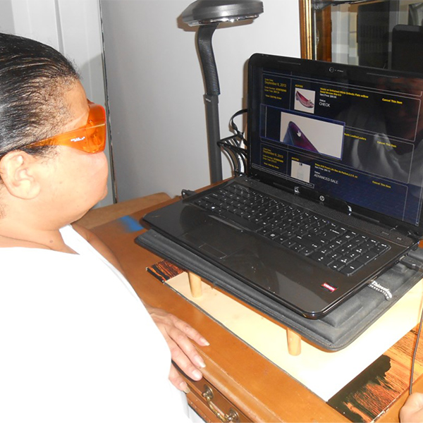Angela using adaptive technology on her laptop