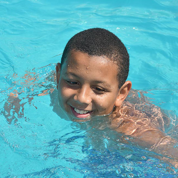 Adventure Camp participant Darius swimming in the pool
