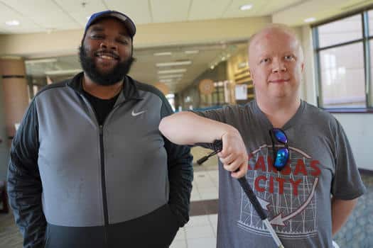 Two men standing side by side. Both of them live with vision loss and come regularly to Gathering Pointe to discuss living with and thriving while blind or visually impaired.